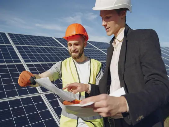A happy industry owner with a solar engineer